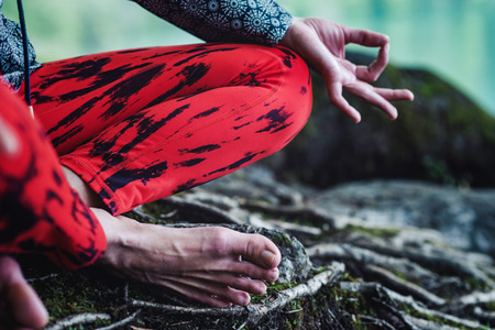 Woman meditating by the lakeの写真素材