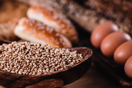 Rye grains in wooden bowl, bakery conceptの写真素材