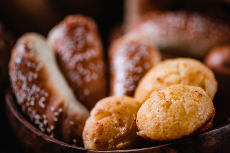 Group of baked goods in wooden bowl, cornbread in focus, bakery conceptの写真素材