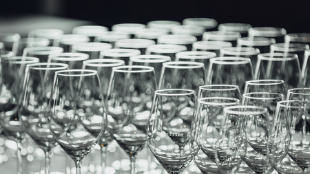Empty wine glasses on table in restaurantの写真素材
