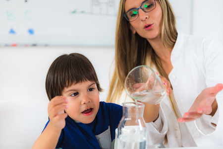 Child psychology, toddler doing tests with water and glassesの写真素材