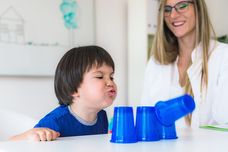 Child psychology, toddler doing tests with plastic cupsの写真素材