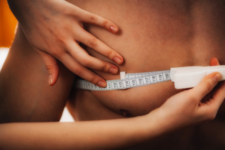 Measuring chest circumference using measurement tape on male athlete.の写真素材