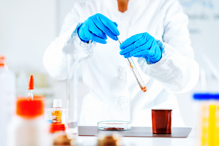 Quality control expert inspecting pudding in the laboratoryの写真素材