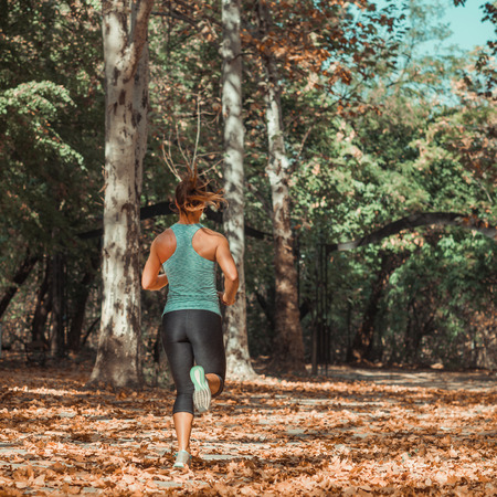 Woman Jogging in Public Park in The Fallの写真素材