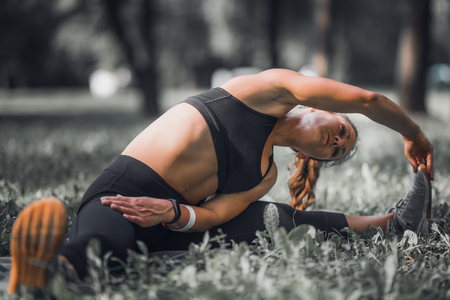 Stretching. Female athlete stretching after exerciseの写真素材