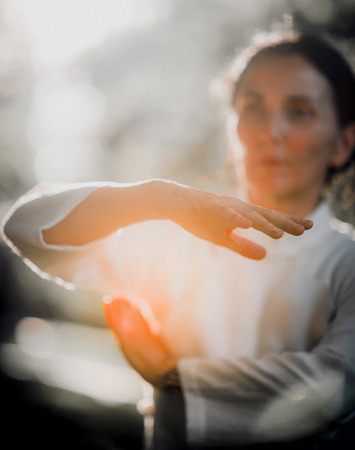 Woman practicing Tai Chi Quan in the parkの写真素材
