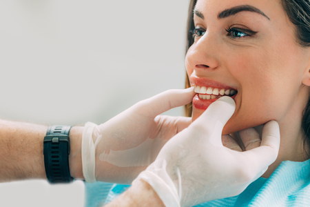 Young smiling woman with beautifiul teeth, having a dental inspectionの写真素材