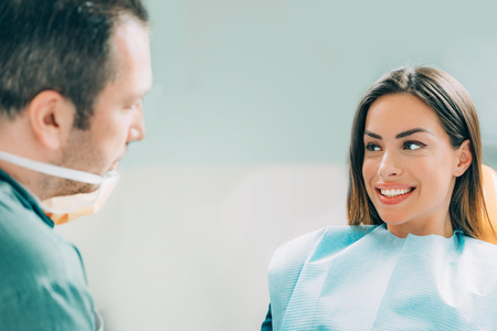 Young smiling woman with beautifiul teeth, having a dental inspectionの写真素材