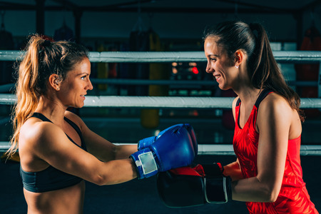 Women saluting after boxing match