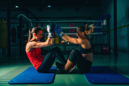 Women on boxing training doing crunchesの写真素材