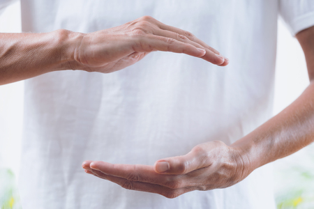 Close up horizontal image of distance healing hands of therapist at Reiki healing treatment. Alternative therapy conceptの写真素材