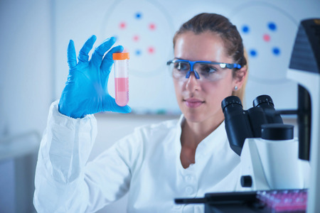 Young female scientist holding liquid sampleの写真素材