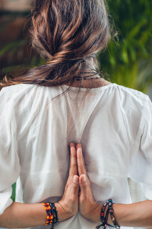 Yoga woman doing reverse prayer pose or penguin pose in studio. Pashchima Namaskarasana or Viparita Namaskarasanaの写真素材