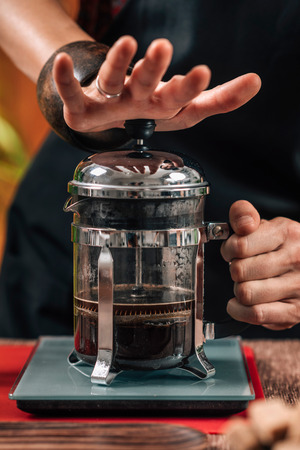 Barista Making French Press Coffee. Close up image of hands female barista making French press coffeeの写真素材