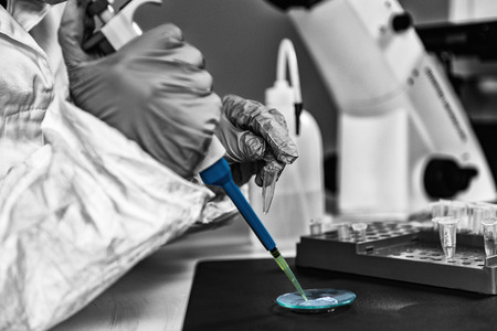 Forensic analyst examining unknown suspicious matter in laboratory.
