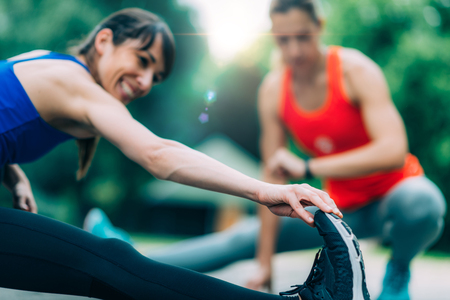 Women stretching after training in the parkの写真素材