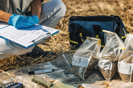 Soil Test. Female agronomist taking notes in the field. Environmental protection, organic soil...