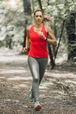 Young Woman Jogging in the Parkの写真素材