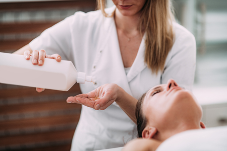 Physiotherapist massaging female patientの写真素材