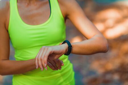 Woman Checking Progress on Smart Watch after Outdoor Training