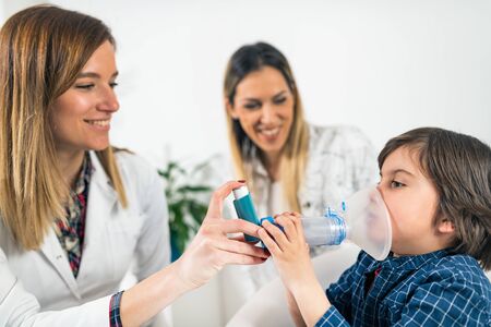 Pulmonology Doctor Helping Little Boy with Inhaler
