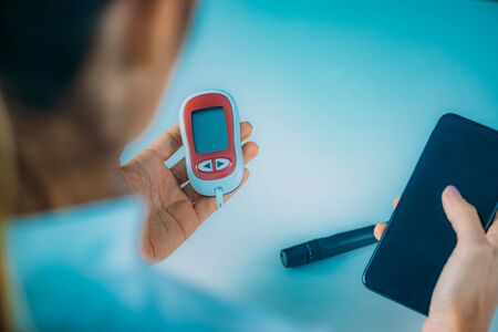 Measuring Glucose Levels and Using Smart Phone App to Follow Resultsの写真素材