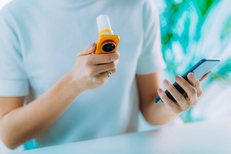 Woman Monitoring Respiratory Illness with Spirometer and Smart Phone App
