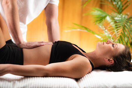 Chiropractor Doing Treatment with Female Athleteの写真素材