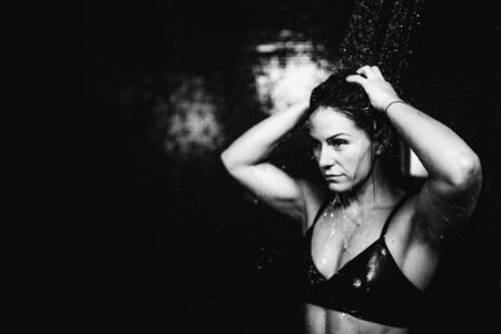Woman under Water Drops. Showering, Black Background.