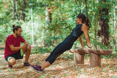 Young Couple Exercising Outdoors, in Park