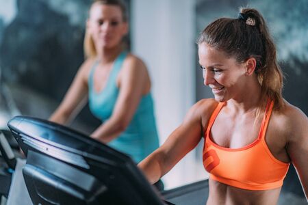 Young Women Exercising on Treadmill.