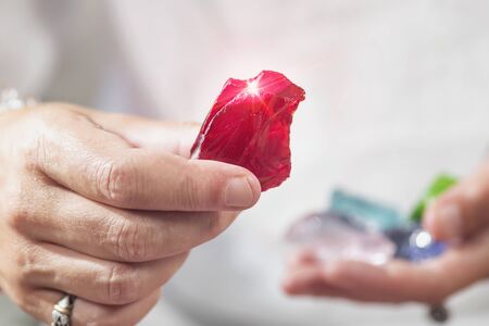 Female crystal healer holding red andara crystal. Alternative medicine concept.の写真素材