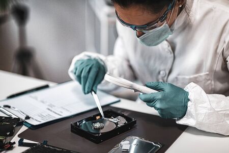 Forensic Science Data. Forensic Analyst Examining Computer Hard Drive.