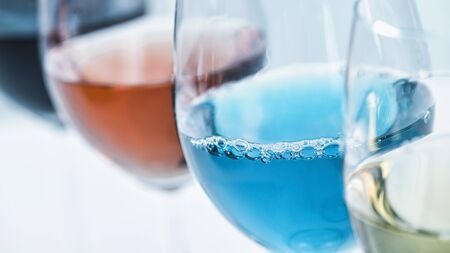 Wine Selection. Four glasses with different wines on table â€“ red, rose, white and blue wine