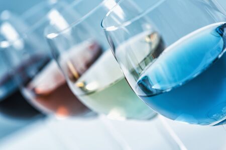 Wine Selection. Four glasses with different wines on table â red, rose, white and blue wineの写真素材