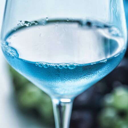 Blue wine and grapes on table.  Close up image with copy space for text.の写真素材