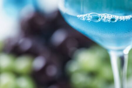 Blue wine and grapes on table.  Close up image with copy space for text.の写真素材