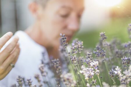 Gratitude - Natural beauty middle age model expressing gratitude to the nature with hands. Healing Through Nature - Giving and receiving energy concept.の写真素材
