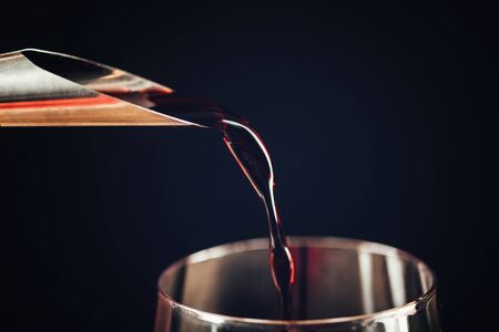 Pouring red wine, close-up