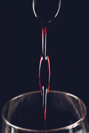 Pouring red wine, close-upの写真素材