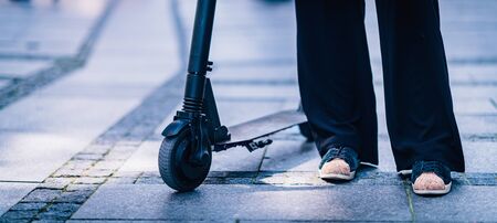 Close Up Image of Woman on Electric Scooter in the City.の写真素材