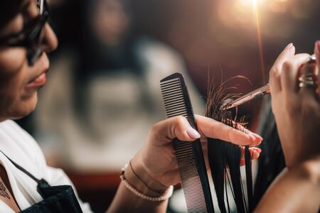 Close-up of a hairdresser cutting womanâs hair.の写真素材