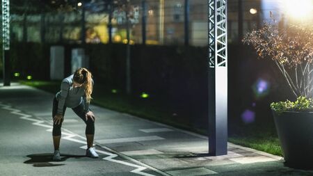 Woman Stretching, Late Night Training in the Cityの写真素材