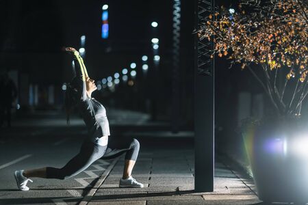 Woman Stretching, Late Night Training in the Cityの写真素材