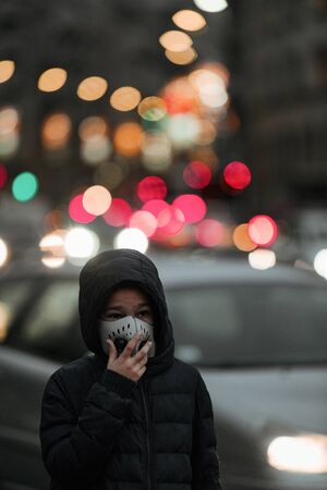 Air Pollution Concept - Young Person with Breathing Mask in the Cityの写真素材