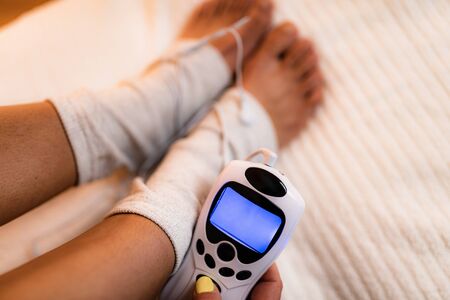 Ankle Joint Physical Therapy with TENS Electrode Brace Pads, Transcutaneous Electrical Nerve Stimulation. の写真素材