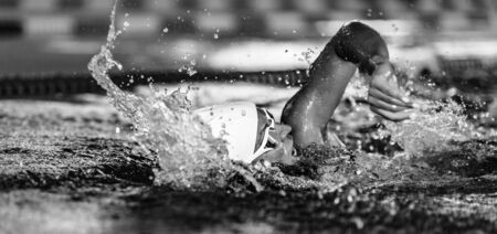 Female swimmer on training in the swimming pool. Front crawl swimming styleの写真素材
