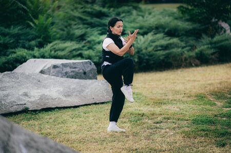 Qi Gong energizing exercise outdoors.