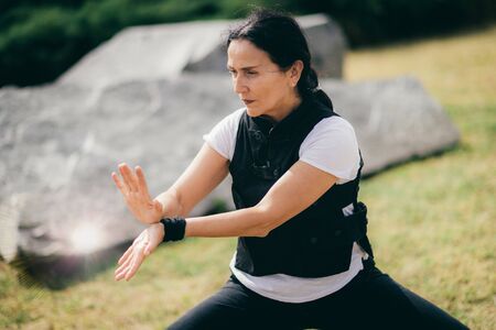 Woman practicing Qi Gong in the park